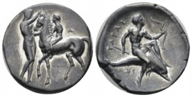 Calabria, Tarentum Nomos circa 335-333, AR 24mm., 7.15g. Nude youth on horseback l.; to l., nude youth standing r., removing bridle with both hands. R...