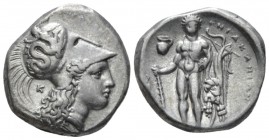 Lucania, Heraclea Nomos circa 330-320 BC, AR 20mm., 7.86g. Head of Athena r., wearing helmet decorated with Scylla hurling stone; behind neck, K. Rev....