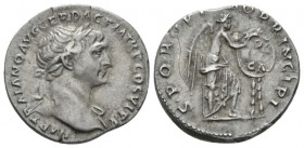 Trajan, 98-117 Denarius circa 111, AR 19mm., 3.23g. Laureate bust r., with drapery on l. shoulder. Rev. Victory standing r., foot on helmet, inscribin...