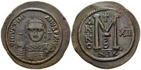 Justinian I, 527-565. Follis Nicomedia circa 538-539, Æ 44mm., 21.73g. Helmeted and cuirassed facing bust, holding globus cruciger and shield; cross t...