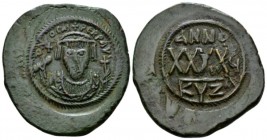 Phocas, 602-610. Follis Cyzicus circa 607-608, Æ 32mm., 12.01g. Crowned bust facing, wearing consular robes, holding mappa and cross; small cross to l...