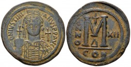 Justinian I, 1 August 527 – 14 November 565 Follis circa 538-539 (year 12), Æ 04mm., 23.36g. Helmeted and cuirassed bust of Justinian facing, holding ...