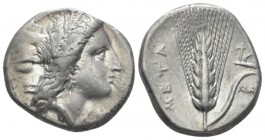 Lucania, Metapontum Nomos circa 330-290 BC, AR 20mm., 7.71g. Head of Demeter r., wearing grain wreath and triple-pendant earring; below chin, ΔAI. Rev...