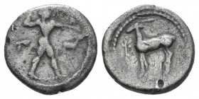 Bruttium, Caulonia Triobol circa 475-425, AR 10.3mm., 1.23g. Apollo standing r., holding branch in r. hand; in field r., stag. Rev. Stag l.; in l. fie...