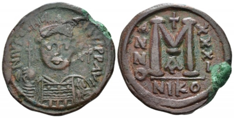 Follis Nicomedia circa 557-558, Æ 32mm., 16.84g. Helmeted and cuirassed facing b...