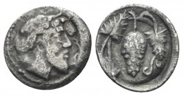 Sicily, Naxos Litra circa 461-430, AR 12mm., 0.45g. Bearded and ivy wreathed of Dionysus r. Rev. Bunch of grapes. Cf. Cahn 74-77. SNG ANS 521. Campana...