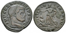 Maxentius, 306-312 Follis circa 310-312, Æ 24mm., 6.59g. Laureate head r. Rev. Victory advancing l. holding palm and wreath; in l. field, captive seat...