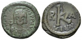 Maurice Tiberius, 582-602 Half Follis Ravenna circa 582-602, Æ 20mm., 5.15g. Helmeted, draped and cuirassed bust facing, holding globus cruciger. Rev:...