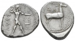 Bruttium, Caulonia Nomos circa 450-445, AR 22mm., 7.97g. KAVΛ Naked Apollo standing right, holding branch in raised r. hand: on extended l. arm small ...