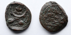 ISLAMIC: Artuqids of Mardin: Nasir al din Mahmud, 1219-1234 AD (616-631 AH), AE Dirham (7.7g).  Obverse: Crowned Turkish female figure seated cross-le...