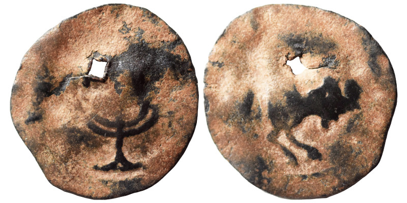 Uncertain period, Ae (bronze, 1.20 g, 21 mm). Bull (?) to right. Rev. Menorah (?...