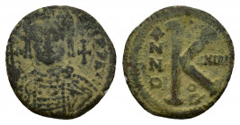 Justinian I (527-565). Æ 20 Nummi (26mm, 9.44g). Theoupolis (Antioch), year 34. Helmeted and cuirassed bust facing, holding globus cruciger and shield...