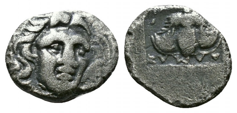 (Silver. 0.77g 11mm) CARIA. Rhodes. Obol (Circa 408-390 BC).
Radiate head of He...