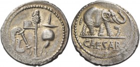 Iulius Caesar. Denarius, mint moving with Caesar 49-48, AR 3.78 g. Pontifical emblems: culullus, aspergillum, axe and apex. Rev. Elephant r., tramplin...