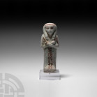 Egyptian Glazed Shabti of Djed Khonsu Iefankh Third Intermediate Period, 21st Dynasty, 1069-943 B.C. A pale-coloured glazed shabti modelled with cross...