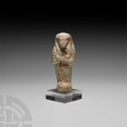 Egyptian Glazed Shabti for the God's Father of Amun Bak-(en)-Khonsu 22nd Dynasty, circa 800 B.C. A pale green-glazed composition shabti with remains o...