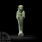 Large Egyptian Hieroglyphic Shabti 26th Dynasty, 664-525 B.C. A large composition turquoise shabti standing on a rectangular base, holding crook and f...