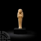 Egyptian Alabaster Shabti New Kingdom-Late Period, 1550-332 B.C. An alabaster mummiform shabti modelled with stylised facial features, crossed arms an...