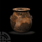 Large Egyptian Predynastic Storage Jar 4th-3rd millennium B.C. A large bulbous limestone storage jar with everted rim and two integral pierced lug han...