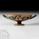 Greek Attic Black-Figure Kylix Eye-Cup Circa 520-500 B.C. A terracotta black-figure kylix composed of a D-section bowl and stemmed foot, bowl exterior...