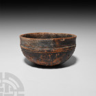 Hellenistic Megarian Bowl with Floral Decoration 3rd-1st century B.C. A hemispherical black-glazed terracotta bowl with everted rim, raised circumfere...