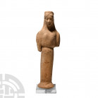 Greek Terracotta Figure of a Kore 6th-5th century B.C. A terracotta figure modelled as a kore standing facing on an integral splayed base, wearing a p...
