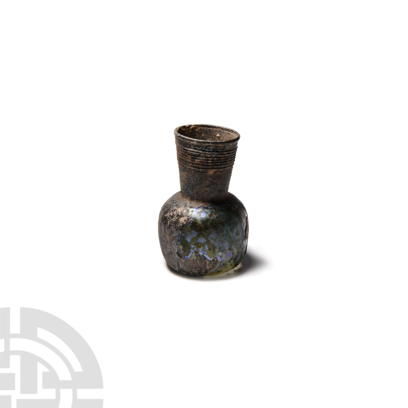 Roman Iridescent Glass Vessel with Ribbed Neck 3rd-4th century A.D. A glass bott...