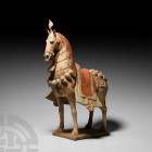 Chinese Northern Wei Caparisoned Horse Northern Wei Dynasty, 386-535 A.D. A ceramic figurine of a horse standing on a rectangular base; integral mould...