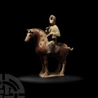 Chinese Tang Horse with Musician Tang Dynasty, 618-907 A.D. A ceramic equestrian figure modelled standing with mounted rider playing a drum, the horse...