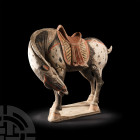 Chinese Tang Dapple Grey Horse with Head Down Tang Dynasty, 618-907 A.D. A ceramic horse modelled in the round, standing with head and neck bent aroun...
