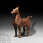 Large Chinese Han Standing Horse Han Dynasty, 206 B.C.-220 A.D. A ceramic standing horse modelled with semi-naturalistic anatomical detailing, head he...
