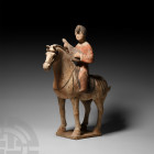 Chinese Tang Mounted Musician Tang Dynasty, 618-907 A.D. A ceramic figurine of a horse and rider on a rectangular base; the horse standing with painte...