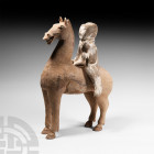 Chinese Han Horse and Rider Figure Group Han Dynasty, 206 B.C.-220 A.D. A ceramic horse and separately modelled rider figure; horse standing with head...