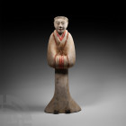 Chinese Han Standing Attendant Han Dynasty, 206 B.C.-220 A.D. A earthenware attendant figure modelled standing, wearing a floor-length courtly robe, a...