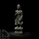 Gandharan Fearless Buddha Shakyamuni on Columned Plinth Circa 2nd century A.D. or later. A bronze Buddha ??kyamuni figure modelled in the round standi...