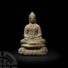 Gandharan Buddha Meditating on Lion Throne Late 2nd century A.D. or later. A Buddha figure modelled in the round meditating on a lotus flower base ado...