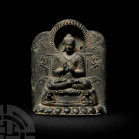 Gandharan Seated Buddha Shakyamuni Preaching on Lion Throne Circa 3rd century A.D. or later. A bronze shrine or altar featuring Buddha Sakyamuni seate...