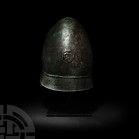 South Italic Greek Pilos Helmet with Gorgoneion Late 4th century B.C. A bronze helmet of Pilos type, conical in shape, comprising a thick hammered bow...