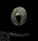 Luristan Stepped Shield 8th century B.C. A hammered discoid shield raised from a single copper-alloy sheet, displaying a central conoid boss surrounde...