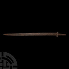 Migration Period Single-Edged Sword Late 5th-early 6th century A.D. A rare long seax, with a finely tapered blade with traces of battle nicks; boat-sh...