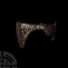 Viking Silver Inlaid Axehead with Beasts 9th-10th century A.D. An iron axehead, triangular in plan with D-shaped socket, square butt, scooped lower pr...