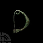Large Greek Bow Brooch 8th-6th century B.C. A bronze brooch with a round-section, leech-shaped body with herringbone decoration, biconvex collars, int...