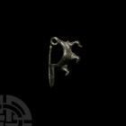Villanovan Figured Leech Fibula Circa 8th-7th century B.C. A bronze Sanguisuga type fibula with triple spiral spring and elongated catch-plate, carryi...