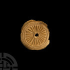 Greek Gold Repousse 'Sun' Disk 5th-3rd century B.C. A sheet-gold disc with repoussé concentric circles and pellets, surrounding a sunburst motif and c...
