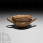 Etruscan Impasto Ware Kylix 7th century B.C. An impasto kylix with carinated body and everted neck, two integral D-shaped handles with tapering, round...