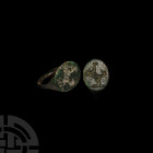 Greek Ring with Rearing Horse 5th-4th century B.C. A bronze ring with lentoid-section hoop and oval-shaped bezel engraved with a horse rearing left, s...