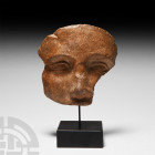 Hellenistic Terracotta Mask 3rd-1st century B.C. A terracotta theatre mask fragment modelled with semi-naturalistic facial features, almandine eyes, s...