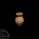 Etrusco-Corinthian Aryballos Circa 7th century B.C. A piriform aryballos (perfume flask) with broad lip and strap handle, painted with circumferential...