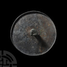 Scythian Mirror with Animal Handle 6th-3rd century B.C. A circular mirror with lip, handle to reverse composed of two cylindrical legs and a sub-trian...