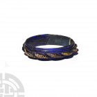 Large Hellenistic Deep Blue Glass Bracelet 3rd-2nd century B.C. A deep blue glass annular bracelet with medial band of raised ropework design embellis...